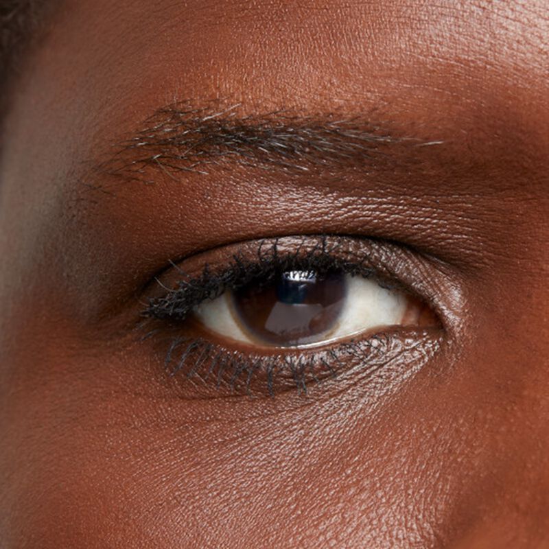 Close-up of deep-skinned model&rsquo;s eye area before using the limited-edition Mary Kay Brow Kit